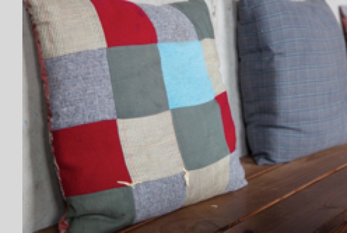 Pillows on benches inside Discretion Brewing Tap Room